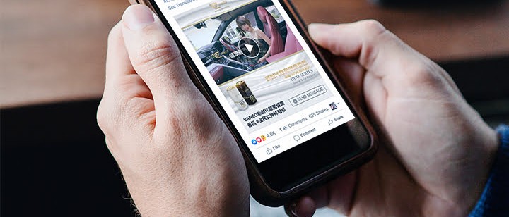 A man viewing an advertisement for Vanzo Asia's car refresher on his iPhone on Facebook.